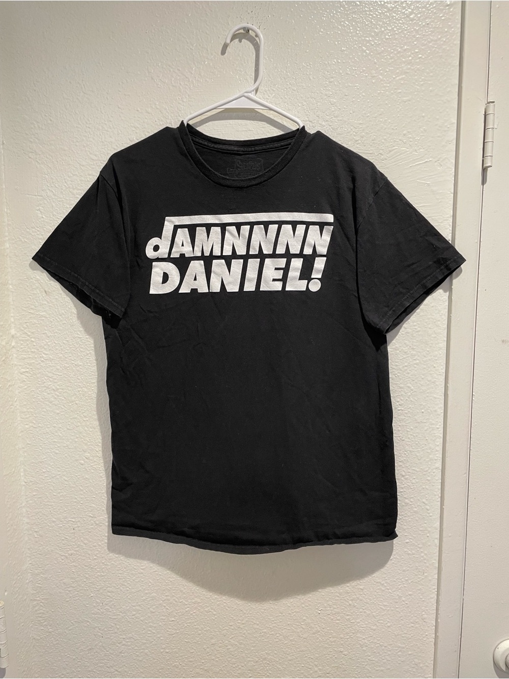 Black Graphic Tee with Bold White 'DANIEL' Print